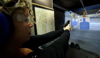 Michelle Morrow practices on the shooting range at the Spring Guns and Amo store Monday, Jan. 4, 2016, in Spring, Texas. President Barack Obama defended his plans to tighten the nation&#x27;s gun-control restrictions on his own, insisting Monday that the steps he&#x27;ll announce fall within his legal authority and uphold the constitutional right to own a gun. (AP Photo/David J. Phillip)