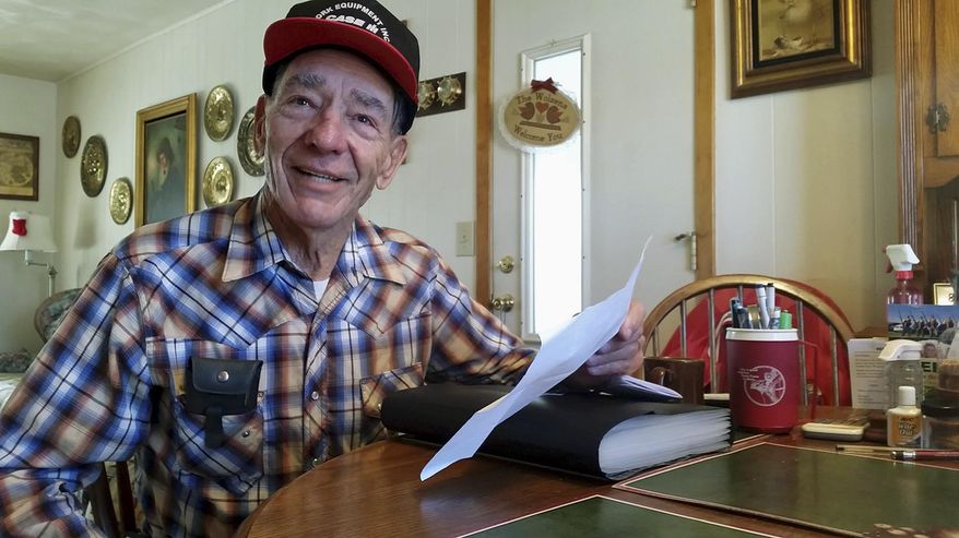 In this Dec. 18, 2015 photo, Stan Wolzen, 78, known to many as “The Dixon Poet,” poses at home in Dixon, Ill. Wolzen has written more than 1,000 poems, including one of his latest, "Here Come the Holidays ... Where Did They Go?” (Christopher Heimerman/Sauk Valley Media via AP)