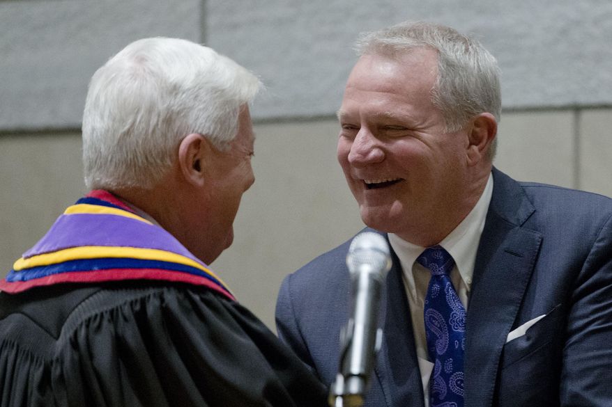 Supreme Court Chief Justice Thomas Saylor, left, greets Kevin Dougherty after he was sworn in as a Pennsylvania Supreme Court Justice Tuesday, Jan. 5, 2016, at the National Constitution Center in Philadelphia. Dougherty and other new members join a court that has been roiled by scandal in recent years. (AP Photo/Matt Rourke)
