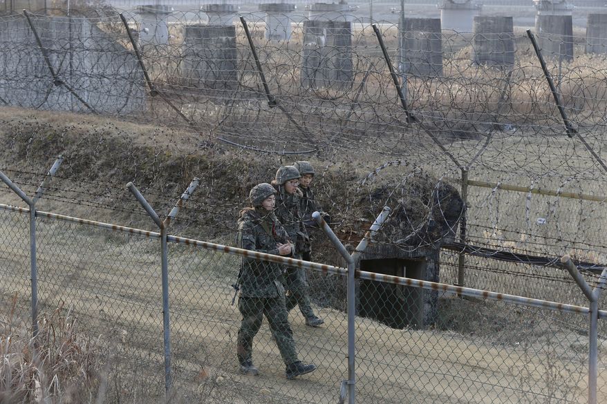 South Korean army soldiers patrol the barbed-wire fence in Paju, near the border with North Korea, South Korea, Wednesday, Jan. 6, 2016. North Korea said it conducted a powerful hydrogen bomb test Wednesday, a defiant and surprising move that, if confirmed, would be a huge jump in Pyongyang's quest to improve its still-limited nuclear arsenal. (AP Photo/Ahn Young-joon)