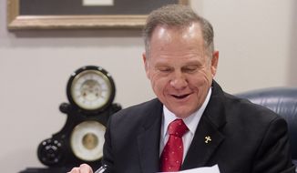 Alabama Chief Justice Roy Moore reads his administrative order discouraging probate judges from issuing same sex marriage licenses, Wednesday, Jan. 6, 2016, at the Alabama Supreme Court building in Montgomery, Ala. The outspoken chief justice, who previously tried to block gay marriage from coming to the Deep South state, issued an administrative order Wednesday saying the Alabama Supreme Court never lifted a March 2015 directive to probate judges to refuse licenses to gay couples.  (Albert Cesare/The Montgomery Advertiser via AP) 