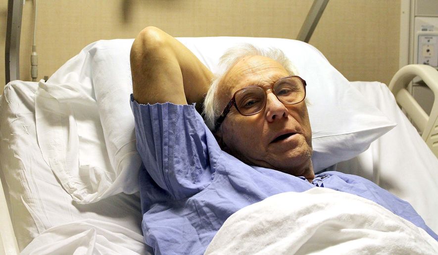 In this photo taken Dec. 23, 2015, Dr. Richard Olson recuperates at the Mayo Cinic Hospital- Saint Mary's Campus in Rochester, Minn., after a surviving a hunting accident in North Dakota. Olson suffered a broken leg on Dec. 19, 2015, and crawled 16 hours across frozen terrain back to his vehicle where he was rescued by a passerby. (Josh Moniz/The Rochester Post-Bulletin via AP) MANDATORY CREDIT