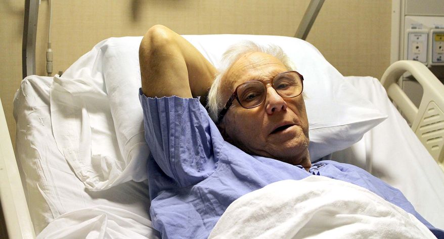 In this photo taken Dec. 23, 2015, Dr. Richard Olson recuperates at the Mayo Cinic Hospital- Saint Mary's Campus in Rochester, Minn., after a surviving a hunting accident in North Dakota. Olson suffered a broken leg on Dec. 19, 2015, and crawled 16 hours across frozen terrain back to his vehicle where he was rescued by a passerby. (Josh Moniz/The Rochester Post-Bulletin via AP) MANDATORY CREDIT