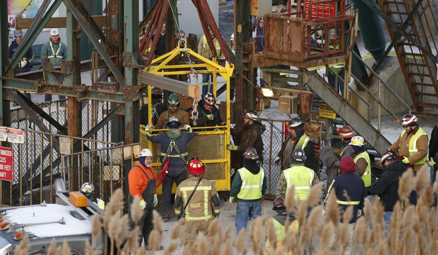 The fourth group of workers emerge from an elevator Thursday, Jan. 7, 2016, after they were stuck overnight in a shaft at the Cayuga Salt Mine in Lansing, N.Y. Cargill Inc. spokesman Mark Klein said all 17 miners have been rescued. (Simon Wheeler/The Ithaca Journal via AP, Pool)