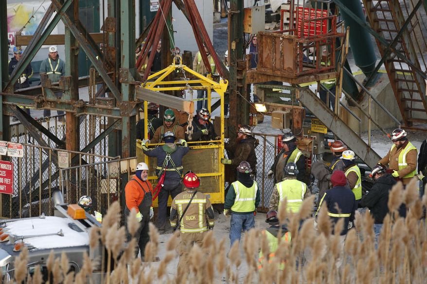The fourth group of workers emerge from an elevator Thursday, Jan. 7, 2016, after they were stuck overnight in a shaft at the Cayuga Salt Mine in Lansing, N.Y. Cargill Inc. spokesman Mark Klein said all 17 miners have been rescued. (Simon Wheeler/The Ithaca Journal via AP, Pool)