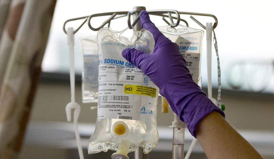 FILE - In this Tuesday, Aug. 4, 2015 file photo, a nurse places a patient&#39;s chemotherapy medication on an intravenous stand at a hospital in Philadelphia.  (AP Photo/Matt Rourke, File)  **FILE**