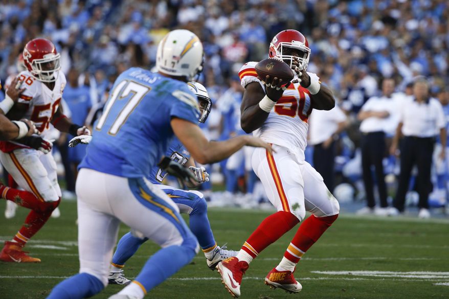 FILE - In this Sunday, Nov. 22, 2015 file photo, Kansas City Chiefs outside linebacker Justin Houston (50) intercepts a pass thrown by San Diego Chargers quarterback Philip Rivers (17) during the second half of an NFL football game in San Diego. Houston scored a touchdown on the play. (AP Photo/Lenny Ignelzi, File)