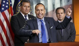 Democratic Reps. Luis Gutierrez (center) of Illinois, Juan Vargas (left) of California and David Cicilline of Rhode Island hold a news conference on Capitol Hill in Washington on Jan. 13, 2015. (Associated Press) **FILE**