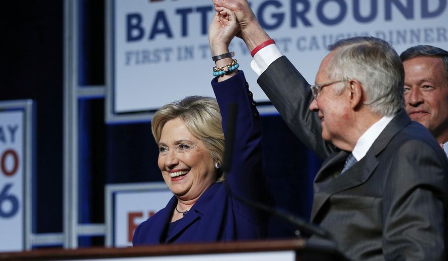 Senate Minority Leader Harry Reid, D-Nev., holds up the hand of Democratic presidential candidate Hillary Clinton on stage at the Battle Born Battleground First in the West Caucus Dinner, Wednesday, Jan. 6, 2016, in Las Vegas. Democratic presidential candidate, former Maryland Gov. Martin O&#x27;Malley is at right. (AP Photo/John Locher) ** FILE **