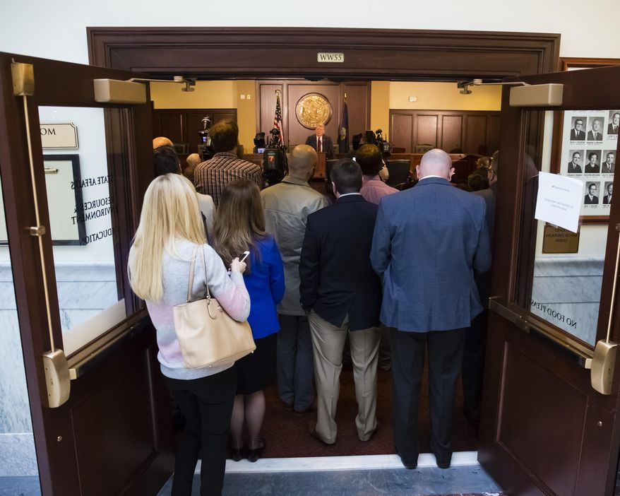 Idaho Gov. C.L. "Butch" Otter, rear, center, speaks to reporters about the upcoming 2016 legislative session at the State Capitol building, Thursday, Jan. 7, 2016, in Boise, Idaho. The new session begins Monday, Jan. 11. (AP Photo/Otto Kitsinger)