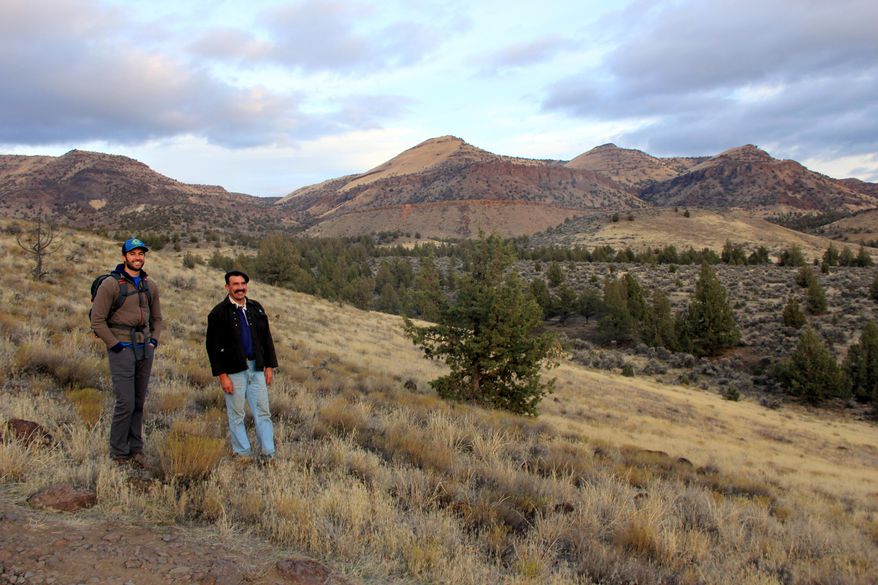 ADVANCE FOR USE SUNDAY, JAN 10 - In this photo take Nov. 11, 2015, Ben Gordon, Oregon Natural Desert Association stewardship director, and Chris Perry, a judge in Wheeler County, pose below Sutton Mountain near Mitchell, Ore. The duo have worked together to craft a wilderness proposal to protect the area near Mitchell. Sutton Mountain is a long, 29,000-acre fault block that rises just above the Painted Hills, a popular tourist destination in the John Day Fossil Beds National Monument. (Zach Urness/Statesman-Journal via AP) MANDATORY CREDIT