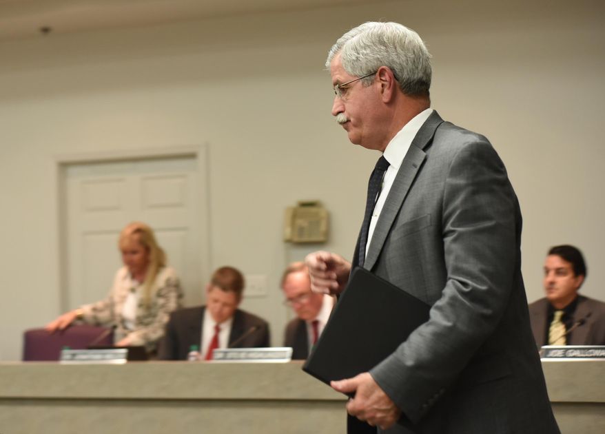 Hamilton County Schools Superintendent Rick Smith enters a school board meeting room before a short public meeting in Chattanooga, Tenn., Wednesday, Jan. 6, 2016. (Tim Barber/Chattanooga Times Free Press via AP)