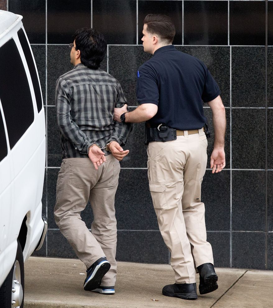 Omar Faraj Saeed Al Hardan, left, is escorted by a U.S. Marshal into the Bob Casey Federal Courthouse on Friday, Jan. 8, 2016, in Houston. He was indicted Wednesday on three charges that he tried to provide material support to extremists. (AP Photo/Bob Levey)
