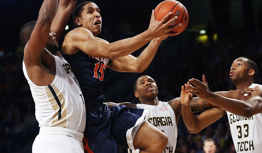 Virginia&#39;s Malcolm Brogdon (15) puts up a shot against Georgia Tech&#39;s Charles Mitchell, from left, Marcus Georges-Hunt, and James White in the first half of an NCAA college basketball game Saturday, Jan. 9, 2016, in Atlanta. (AP Photo/David Goldman)