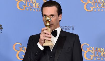 Jon Hamm poses in the press room with the award for best performance by an actor in a TV series - drama for &quot;Mad Men&quot; at the 73rd annual Golden Globe Awards on Sunday in Beverly Hills, Calif. (Associated Press)