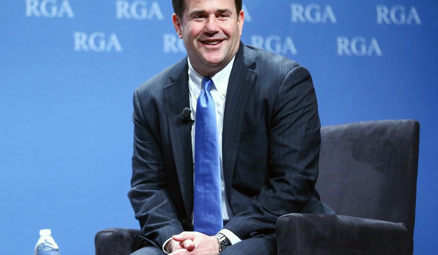 FILE - This Nov. 18, 2015, file photo, shows Arizona Gov. Doug Ducey participating in a panel discussion during the Republican Governors Association annual conference in Las Vegas. Ducey faced a massive budget deficit when he took office last year, but the tables have turned this year as relatively small budget cuts and a surge in revenue erased the deficit. He now will have a big surplus, but is vowing to maintain a tight fiscal leash on state spending despite pressure from schools and other groups to restores funding cuts. (AP Photo/Chase Stevens, File)