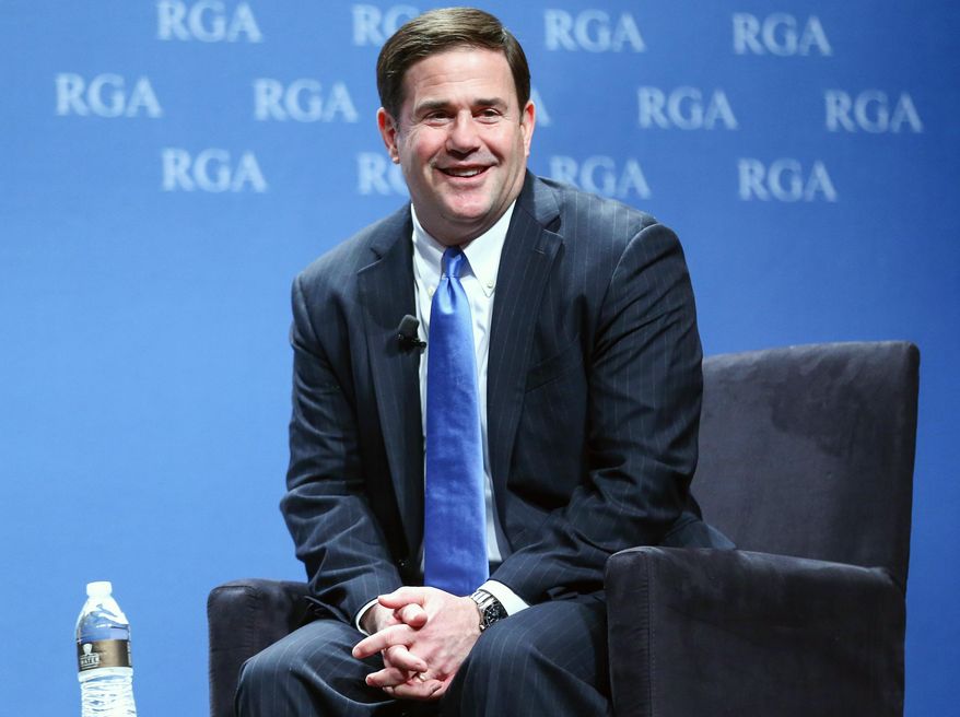 FILE - This Nov. 18, 2015, file photo, shows Arizona Gov. Doug Ducey participating in a panel discussion during the Republican Governors Association annual conference in Las Vegas. Ducey faced a massive budget deficit when he took office last year, but the tables have turned this year as relatively small budget cuts and a surge in revenue erased the deficit. He now will have a big surplus, but is vowing to maintain a tight fiscal leash on state spending despite pressure from schools and other groups to restores funding cuts. (AP Photo/Chase Stevens, File)