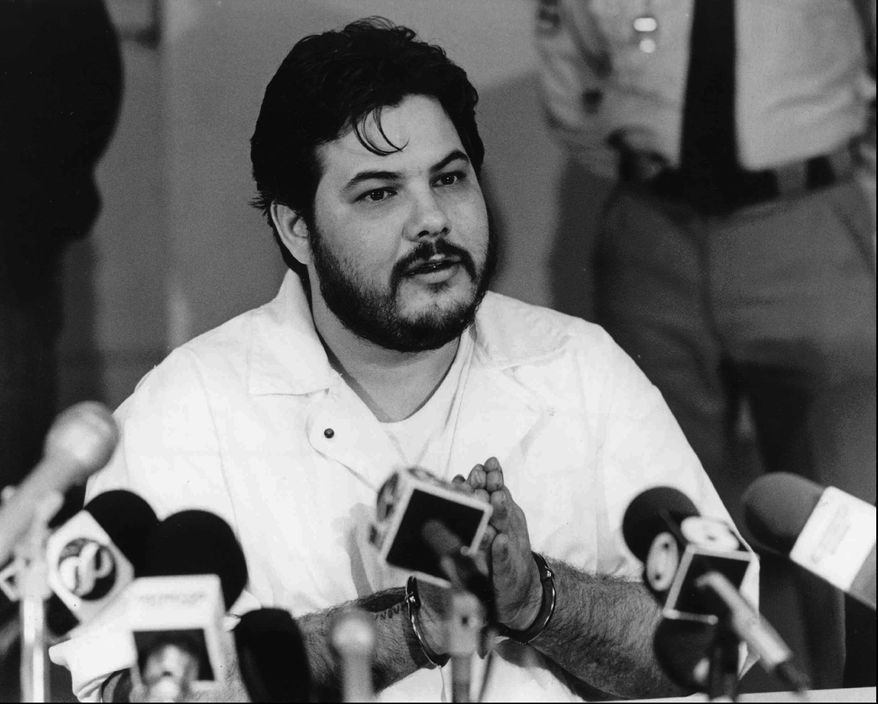In this 1991 photo, Joseph M. Giarratano, who was stabbed on July 4, 1996, at Buckingham Correctional Center, speaks with members of the media in Buckingham, Va. Giarratano came within three days of being executed in February 1991 before then Gov. L. Douglas Wilder granted him a conditional pardon and commuted his death sentence. (Lindy Keast Rodman/Richmond Times-Dispatch via AP) MANDATORY CREDIT