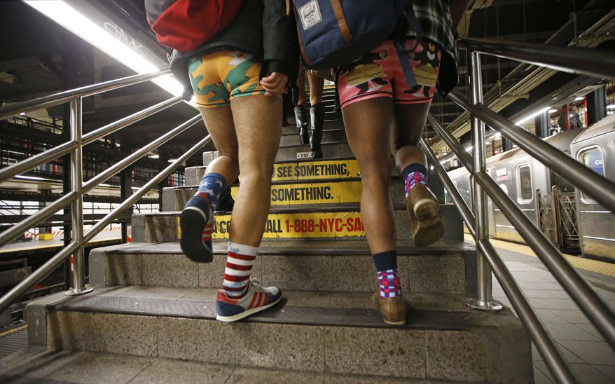 Two men clad in colorful underwear walk up the subway steps during the 15th annual No Pants Subway Ride on Sunday in New York. The group event, a prank meant to amuse, has been going on since 2002. (Associated Press)
