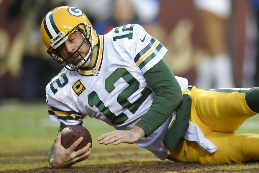 Green Bay Packers quarterback Aaron Rodgers (12) bounces off the turf in the end zone after being sacked for a safety during the first half of an NFL wild card playoff football game against the Washington Redskins in Landover, Md., Sunday, Jan. 10, 2016. (AP Photo/Nick Wass)