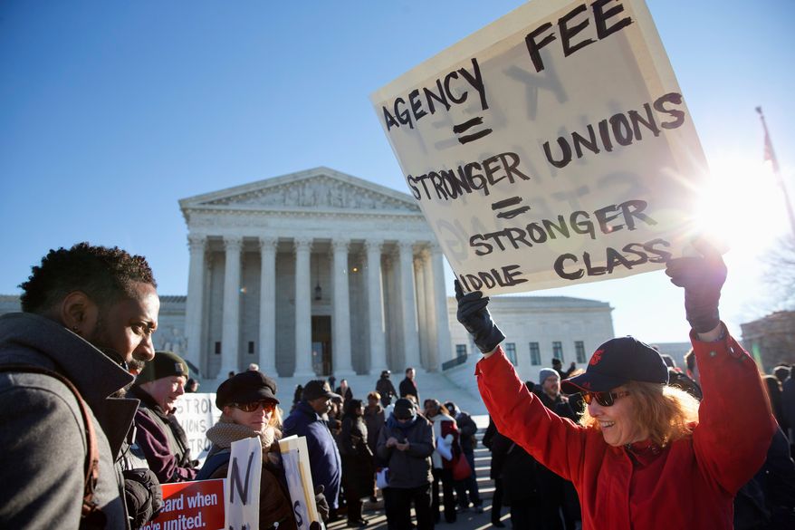 Union supporters rally at the Supreme Court Monday as the court heard arguments in Friedrichs v. California Teachers Association, a case that challenges the right of public employee unions to collect fees from workers who opt out of membership. (Associated Press)
