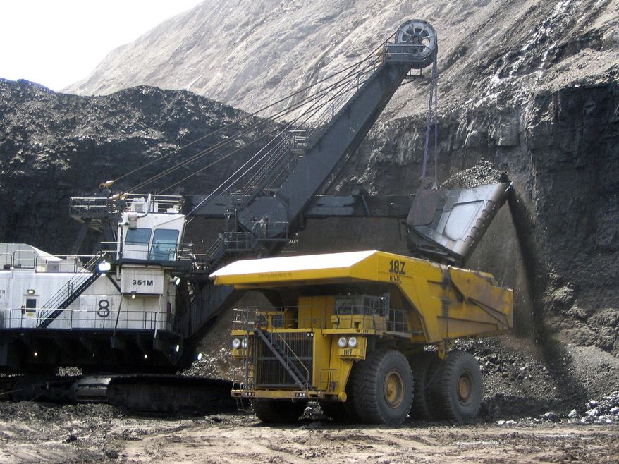 FILE - In this April 30, 2007, file photo, a shovel prepares to dump a load of coal into a 320-ton truck at the Black Thunder mine in Wright, Wyo. The mine is owned by St. Louis-based Arch Coal Inc. which says its Chapter 11 filing will not affect employee pay or benefits while the company reorganizes its debt. (AP Photo/Matthew Brown, File)