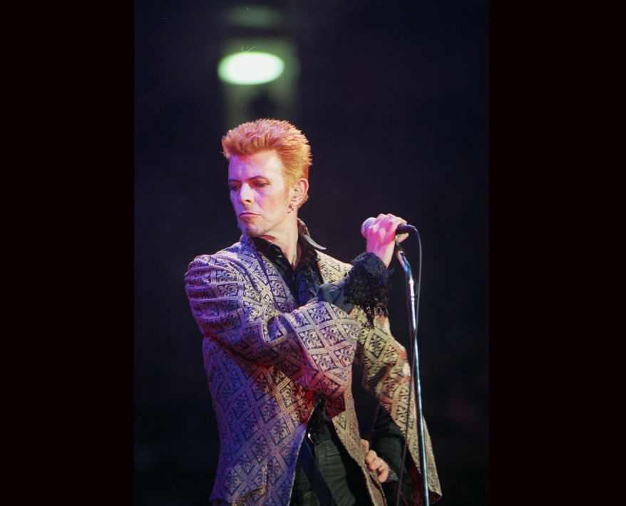 CORRECTS DATE OF DEATH TO SUNDAY, JAN. 10, 2016 - FILE - In this Jan. 9, 1997, file photo, David Bowie performs during a concert celebrating his 50th birthday, at Madison Square Garden in New York. Bowie, the innovative and iconic singer whose illustrious career lasted five decades, died Sunday, Jan. 10, 2016, after battling cancer for 18 months. He was 69. (AP Photo/Ron Frehm, File)