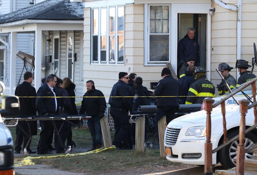 Emergency personnel gather Monday, Jan. 11, 2016 at a house where four people were found dead late Sunday after a fire in Rochester, NY. Officials say firefighters found the bodies of four people, two men and two women, while battling the blaze. The fire has been deemed suspicious, but officials haven't released any details of what may have caused the fire or what killed the four victims. (Tina Macintyre-Yee/Democrat & Chronicle via AP) MAGS OUT; NO SALES; MANDATORY CREDIT