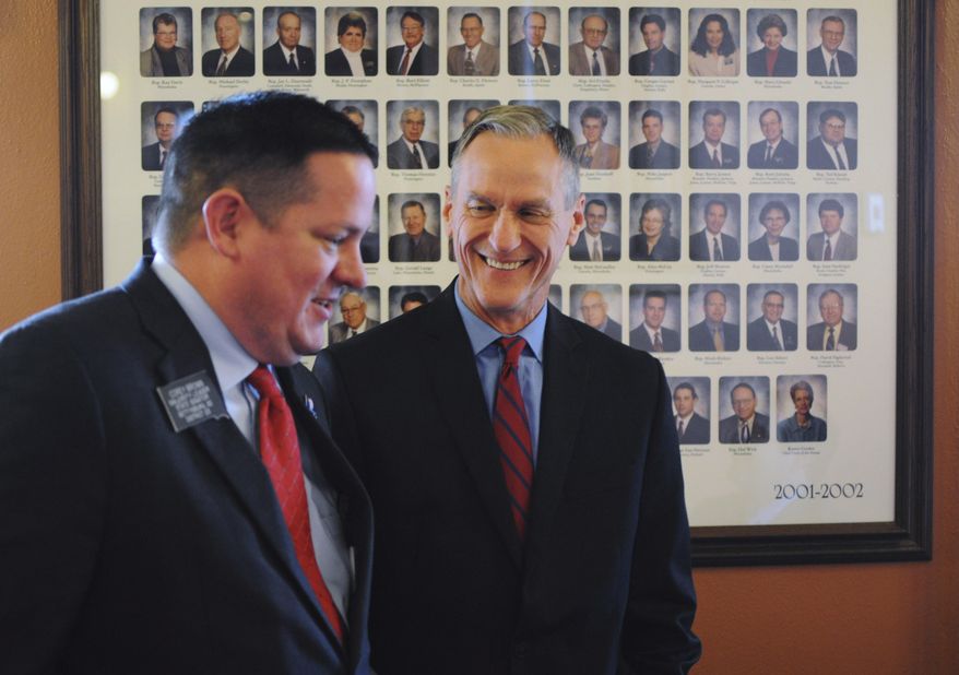 FILE - In this Dec. 8, 2015 file photo, South Dakota Gov. Dennis Daugaard speaks with Senate Majority Leader Corey Brown shortly before the governor outlined his proposed budget for the 2016 legislative session at the state Capitol in Pierre, S.D. Daugaard will give his state of the state address Tuesday, Jan. 12 to kick off the 2016 legislative session. (AP Photo/James Nord, File)