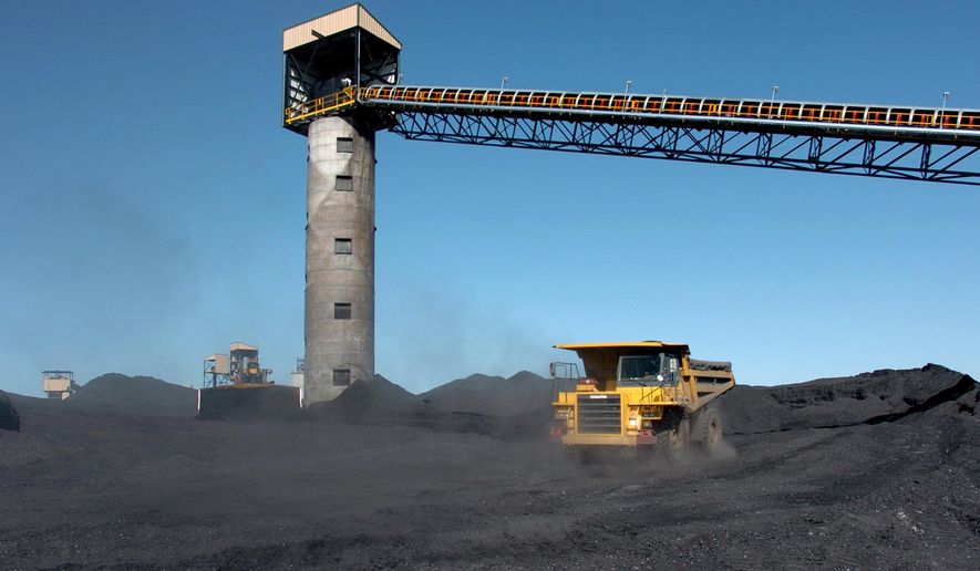 FILE - In this Aug. 28, 2009, file photo, heavy equipment moves coal outside Signal Peak Energy’s Bull Mountain mine near Roundup, Mont. A central Montana coal mine reached an agreement Monday, Jan. 11, 2016, with environmentalists and state regulators that is intended to avoid a major shutdown as a declining coal market leaves the future of some mining companies in doubt. The deal comes after a state review panel rejected an expansion permit granted to the Bull Mountain Mine in 2013, threatening to halt most operations if the dispute could not be resolved. (AP Photo/Matthew Brown, File)