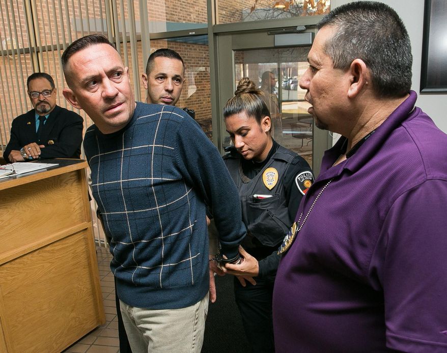 Stephen Siddall is arrested by Las Cruces Police Department Detective Robert Campos, right, and LCPD officer Veronica De La O on Monday, Jan. 11, 2016, at 3rd Judicial District Court on charges of embezzlement in the Sen. Mary Kay Papen case. In the moments prior to the arrest, Siddall was in court before Judge Mary W. Rosner for arraignment in a embezzlement case concerning Papen's son-in-law, City Councilor Greg Smith. (Robin Zielinski/Las Cruces Sun-News via AP)