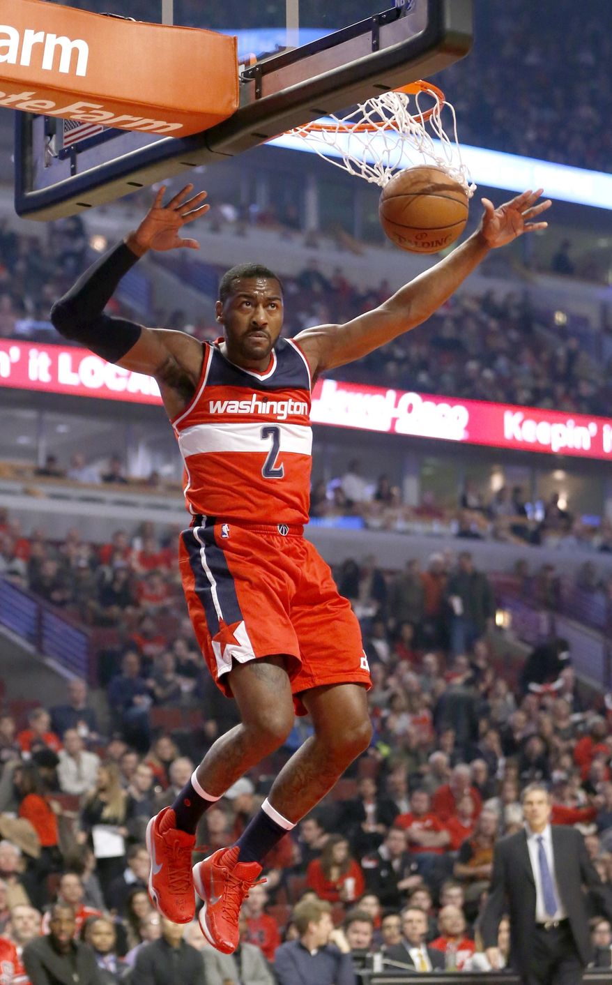 Washington Wizards guard John Wall dunks the ball during the first half of an NBA basketball game against the Chicago Bulls, Monday, Jan. 11, 2016, in Chicago. (AP Photo/Charles Rex Arbogast)