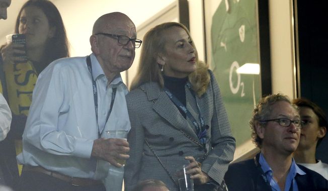 Media mogul Rupert Murdoch stands with model Jerry Hall during the Rugby World Cup final between New Zealand and Australia at Twickenham Stadium, London, during this Nov. 1, 2015, file photo. Murdoch has announced his engagement to Hall, the actress and former supermodel who had a long-time relationship with Mick Jagger, Monday, Jan. 11, 2016. (AP Photo/Alastair Grant, File)