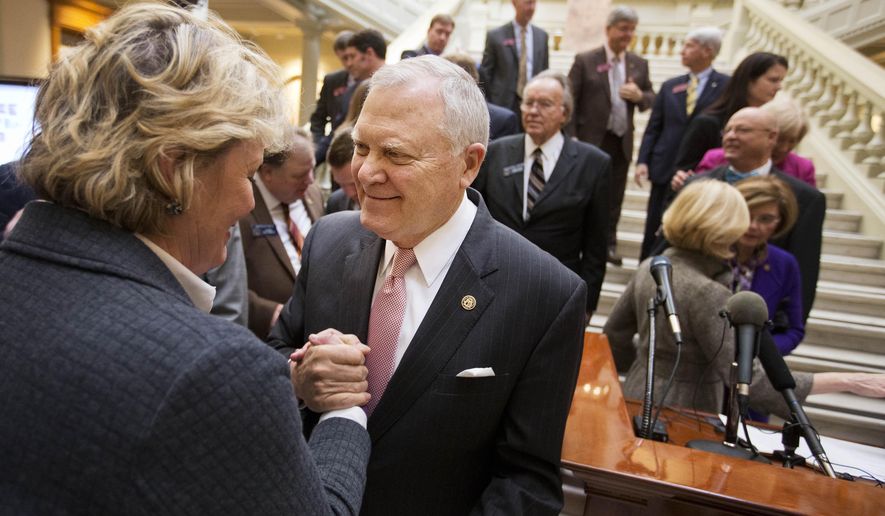 Georgia Gov. Nathan Deal, right, is greeted by lobbyist Yvonne Willams after unveiling details of a plan to improve transportation in the state during a press conference at the Capitol Tuesday, Jan. 12, 2016, in Atlanta. (AP Photo/David Goldman)