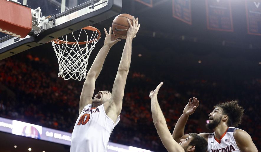 Virginia center Mike Tobey (10) grabs a rebound before dunking during the first half of an NCAA college basketball game against Miami in Charlottesville, Va., on Tuesday, Jan. 12, 2016. (AP Photo/Ryan M. Kelly)