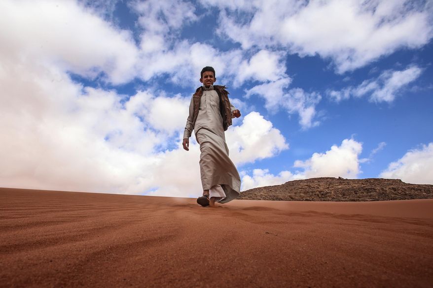 In this Saturday, Jan. 9, 2016 photo, Jacir Eid Al-Hwietat, 15, poses for a photo in Wadi Rum, a scenic desert area of southern Jordan. Jacir and his cousin, both from a Bedouin clan, acted in the film "Theeb" (Wolf), a coming-of-age drama set in 1916, that has emerged as the first Oscar contender of Jordan’s nascent film industry. The final five will be announced Thursday. (AP Photo/ Raad Adayleh)