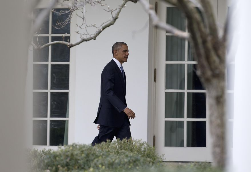 President Barack Obama walks along the colonnade of the White House in Washington, Tuesday, Jan. 12, 2016, to the residence from the Oval Office hours before giving his State Of The Union address. (AP Photo/Carolyn Kaster)
