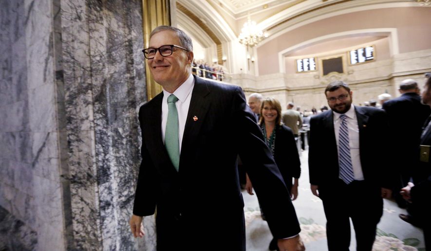 Gov. Jay Inslee smiles as he leaves the House Chambers following his annual State of the State address Tuesday, Jan. 12, 2016, in Olympia, Wash. The address came on the second day of the 60-day legislative session. (AP Photo/Elaine Thompson)