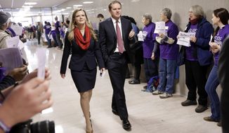 Rep. Jeremy Durham, R-Franklin, and his wife, Dr. Jessica Durham, walk past protesters advocating for the passage of Gov. Bill Haslam&#x27;s Medicaid expansion proposal as the Durhams walk to the Capitol on the opening day of the second session of the 109th General Assembly Tuesday, Jan. 12, 2016, in Nashville, Tenn. Rep. Durham was the sponsor of the law that required Haslam to seek Legislative approval for any effort to seek Medicaid expansion. (AP Photo/Mark Humphrey) **FILE**
