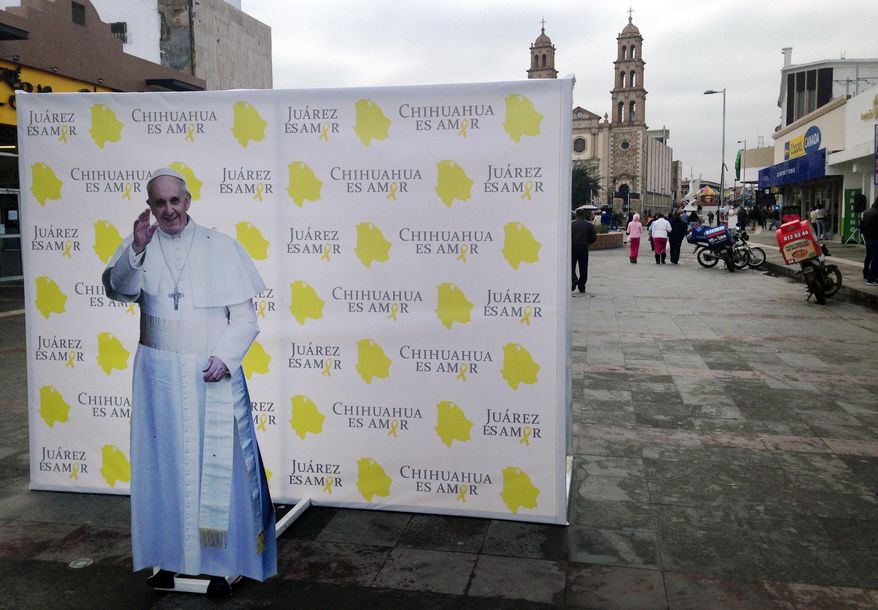 This photo taken Jan. 5, 2016, shows an installation of Pope Francis advertising the pope's upcoming visit to Juarez, Mexico. The city, on Mexico's northern border across from El Paso, Texas, is the last stop in the Pope's schedule 5-day trip to Mexico and officials on both sides of the border are preparing for the visit between Feb. 12-17. (AP Photo/Russell Contreras)