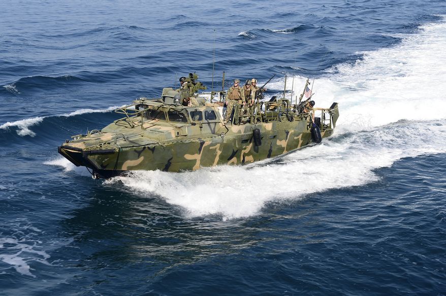 In this Nov. 15, 2014, photo, a Riverine Command Boat from Costal Riverine Squadron (RIVRON) 2 escorts the USS Bunker Hill (CG 52) in the Persian Gulf. Iran was holding 10 U.S. Navy sailors and their two boats, similar to the one in this picture, on Jan. 12, 2016, after the boats had mechanical problems and drifted into Iranian waters. (LaTunya Howard/U.S. Navy via AP)