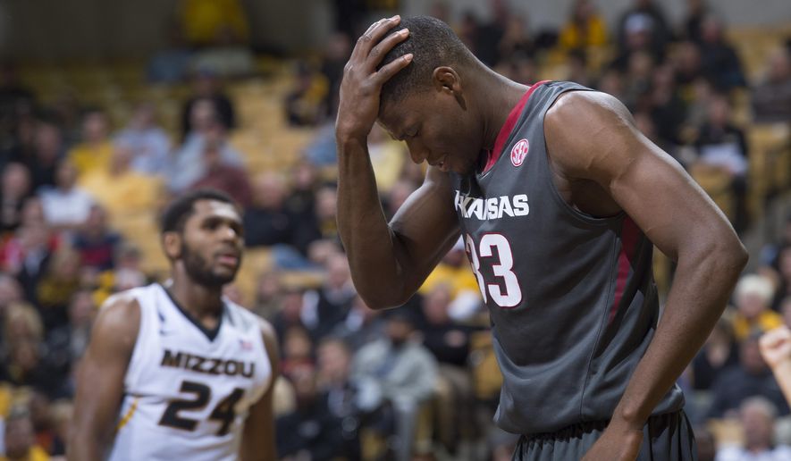 Arkansas’ Moses Kingsley, right, holds his head as Missouri&#39;s Kevin Puryear walks in the background, after Kingsley was fouled during the second half of an NCAA college basketball game, Tuesday, Jan. 12, 2016, in Columbia, Mo. Arkansas won the game 94-61. (AP Photo/L.G. Patterson)