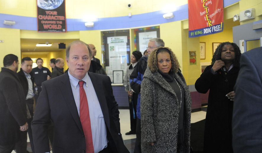 Detroit Mayor Mike Duggan, left, leaves Fisher Magnet Lower Academy in Detroit, Tuesday, Jan. 12, 2016, after talking with school administrators and Detroit Public Schools officials about the condition of the school. The visits occurred while two dozen schools were closed because of a sick-out by teachers who are upset about pay, class sizes, rodents and mold. (Jose Juarez/Detroit News via AP) DETROIT FREE PRESS OUT; HUFFINGTON POST OUT; MANDATORY CREDIT