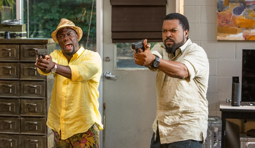 This photo provided by Universal Pictures shows, Kevin Hart, left, as Ben Barber and Ice Cube as James Payton in a scene from the film, "Ride Along 2." The movie opens in U.S. theaters on Jan. 15, 2016. (Quantrell D. Colbert/Universal Pictures via AP)