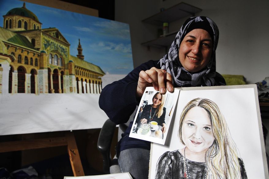 In this Thursday, Jan. 7, 2016 photo, Lina Mahameed, a Syrian artist and refugee from Daraa, holds a color portrait she drew of one of the people killed in the Nov. 13 attacks in Paris by the Islamic State extremist group, next to a photo of the victim she downloaded from the Internet, in Amman, Jordan. Mahameed hopes to send her portraits to the victims' families to show that “their tragedy is like our tragedy.” Mahameed said they fell victim to the same fanaticism that killed her 16-year-old son Yasser at the beginning of Syria’s civil war. (AP Photo/Sam McNeil)