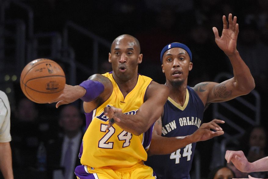 Los Angeles Lakers forward Kobe Bryant, left, passes the ball as New Orleans Pelicans forward Dante Cunningham defends during the first half of an NBA basketball game, Tuesday, Jan. 12, 2016, in Los Angeles. (AP Photo/Mark J. Terrill)