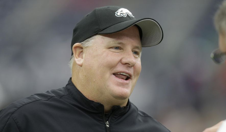 FILE - In this Nov. 2, 2014, file photo, Philadelphia Eagles head coach Chip Kelly watches his team during warm ups before the start of an NFL football game against the Houston Texans, in Houston. The San Francisco 49ers have hired Chip Kelly as their new head coach. CEO Jed York announced the move on Twitter and so did the team. (AP Photo/Patric Schneider, File)