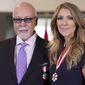 This July 26, 2013, file photo shows Canadian music star Celine Dion, right, and husband Rene Angelil posing for photos after being decorated with the Order of Canada in Quebec City. Authorities say Angelil, the husband and manager of Dion, has died in Las Vegas. He was 73 and had battled throat cancer.  Clark County Coroner John Fudenberg said his office was notified Thursday, Jan. 14, 2016, of Angelil’s death. (Jacques Boissinot/The Canadian Press, File)