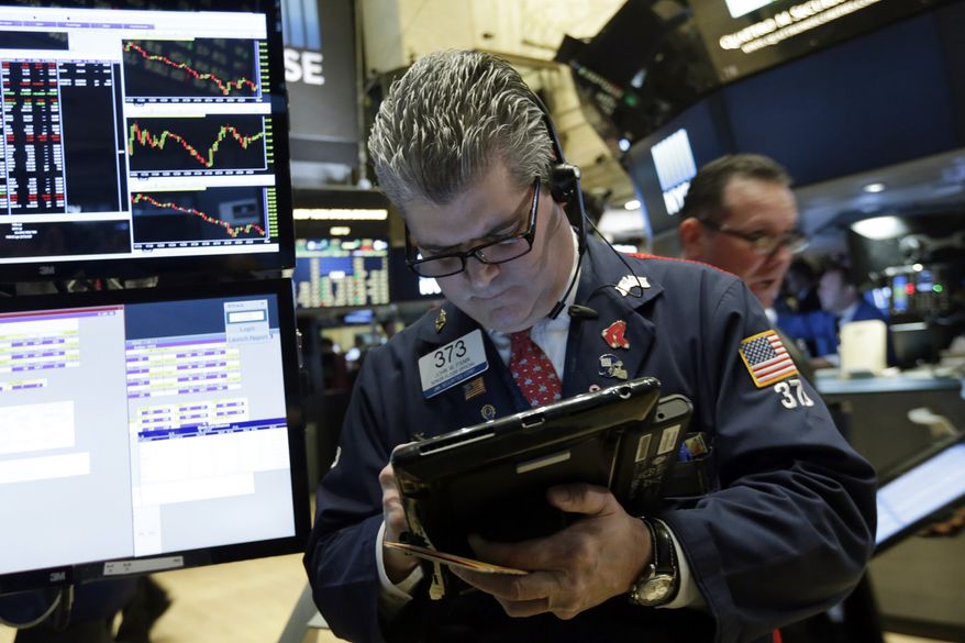 Trader John Panin works on the floor of the New York Stock Exchange, Thursday, Jan. 14, 2016. U.S. stocks moved slightly lower in early trading Thursday, extending losses following the worst market drop since September. Investors had their eye on the latest company earnings and outlooks. Consumer discretionary stocks were among the biggest decliners. (AP Photo/Richard Drew)
