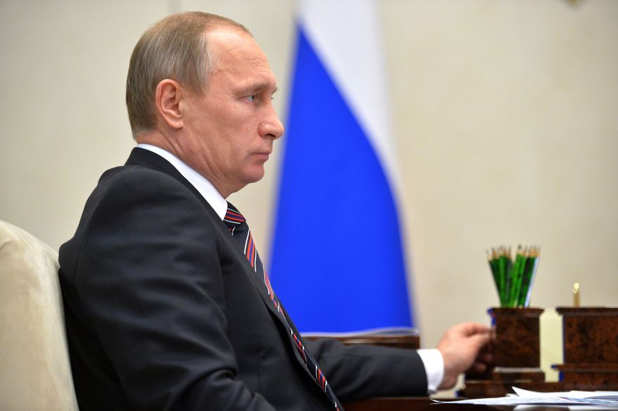 In this photo taken on Wednesday, Jan. 13, 2016, Russian President Vladimir Putin attends a meeting at the Novo-Ogaryovo residence outside Moscow, Russia. U.S. President Barack Obama and Putin joined Wednesday in calling for a tough global response to North Korea's recent nuclear test, even as they remained at odds over Ukraine and Syrian President Bashar Assad. (Alexei Druzhinin/Sputnik, Kremlin Pool Photo via AP)